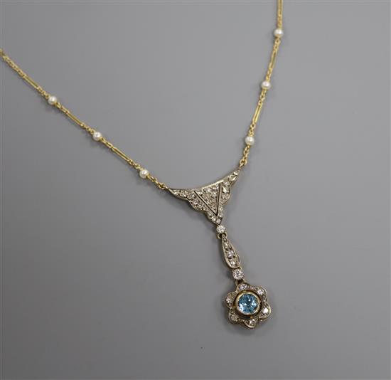 An Edwardian style yellow metal, blue topaz, diamond and seed pearl set drop pendant necklace, pendant 5cm.